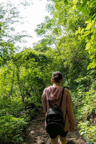 young woman descending in the ravine, vegetation and trees, huentitan ravine guadalajara, mexico, latin america - Photo, image
