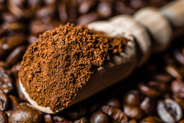 Ground coffee in scoop and coffee beans. - Фото, изображение
