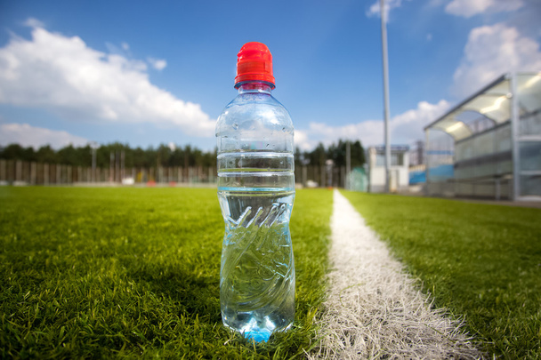 Closeup shot of bottle of water of soccer field during match - Photo, Image