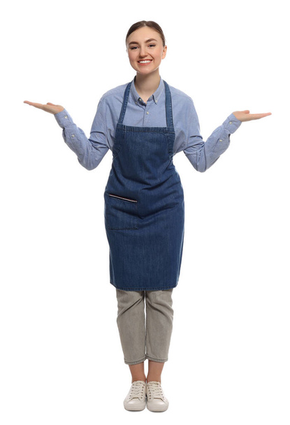 Beautiful young woman in clean denim apron on white background - 写真・画像