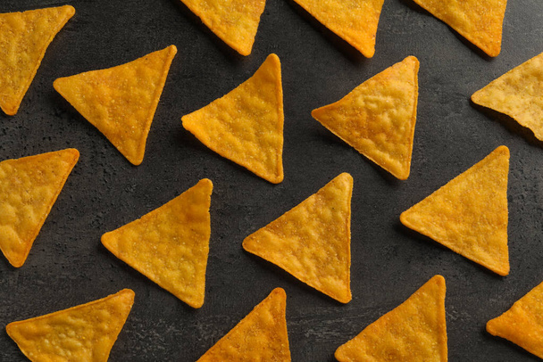 Flat lay composition of tasty tortilla chips (nachos) on grey table - 写真・画像