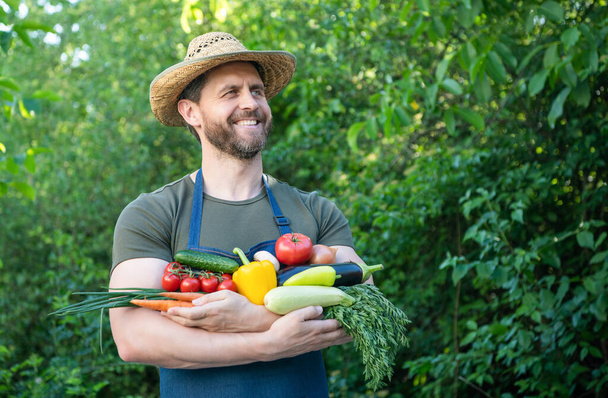 farmer in straw hat hold fresh ripe vegetables. - Fotó, kép