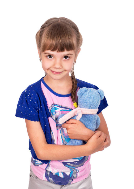 Little girl holding a teddy bear. Isolated on white background. Girl hugging two teddybears. - Foto, afbeelding