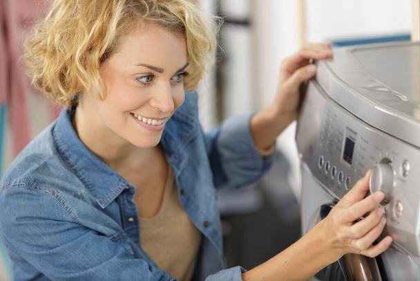 woman preparing a washing machine - 写真・画像