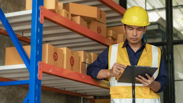 Asian man managing warehouse worker man holding tablet in warehouse Logistics network distribution and intelligent logistics, import, eksport, and industrial concepts.. box transport - Zdjęcie, obraz
