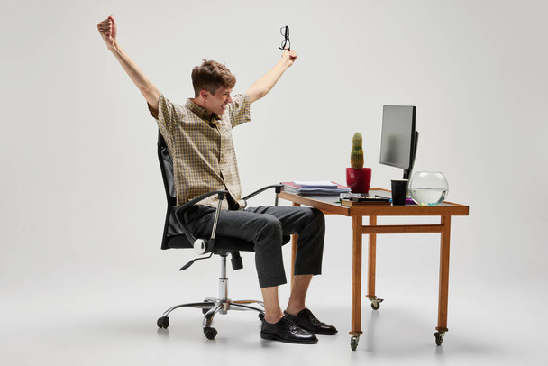 Success, wow. Happy and cheerful student sitting at computer desk and studying. Business, emotions, studying, home education, youth, remote workplace concept.Copy space for text - Φωτογραφία, εικόνα