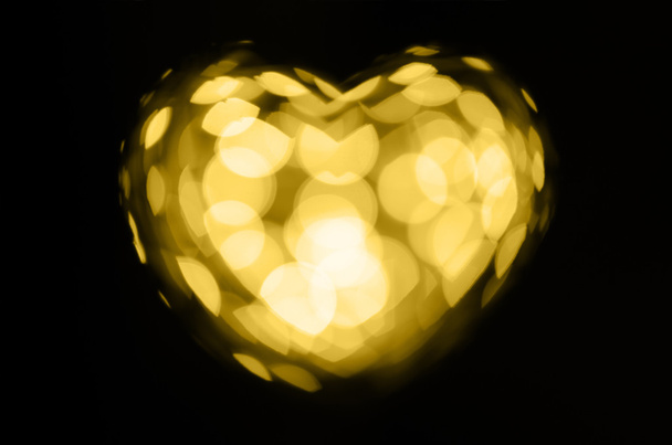Coração de bokeh dourado no fundo preto
 - Foto, Imagem