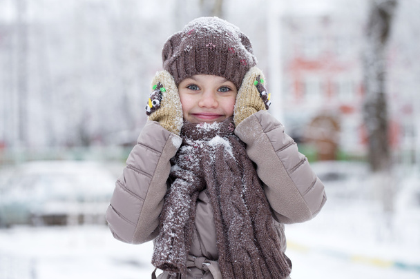 Happy little girl on the background of a winter park - 写真・画像