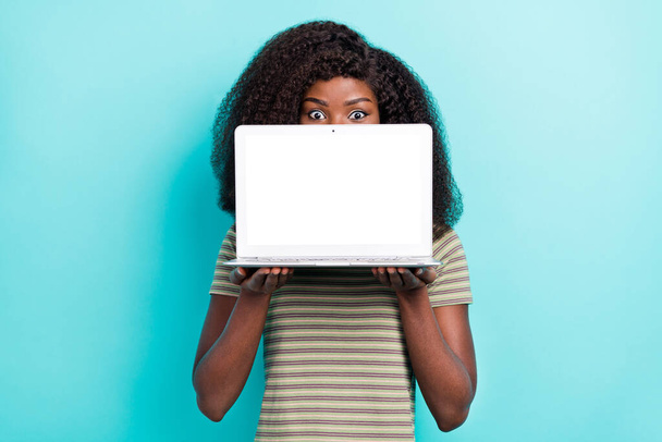 Photo of young person hold demonstrate empty space netbook display cover face isolated on aquamarine color background. - Photo, Image