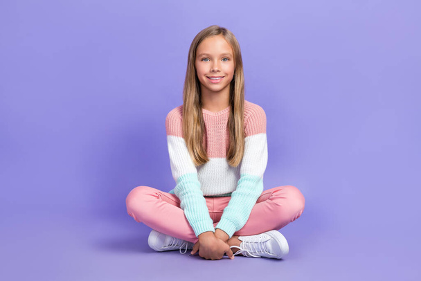Full length photo of satisfied girl legs crossed dressed colorful sweater jumper clothes good mood isolated on purple color background. - Фото, зображення