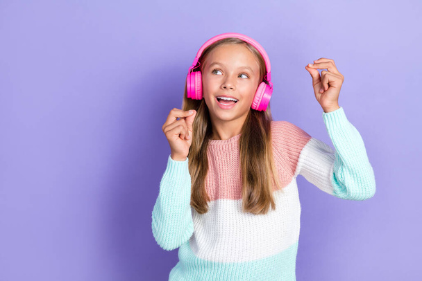 Photo of positive cool girl meloman look empty space promo sale shop modern technology ear accessory isolated on purple color background. - Photo, image