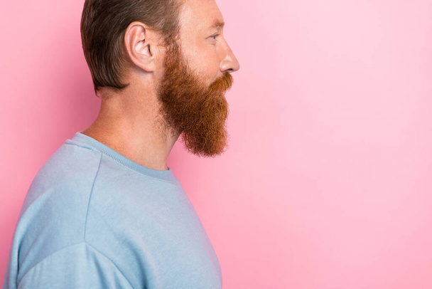 Side profile photo of confident handsome glad man red hairstyle wear blue sweatshirt look empty space isolated on pink color background. - Φωτογραφία, εικόνα