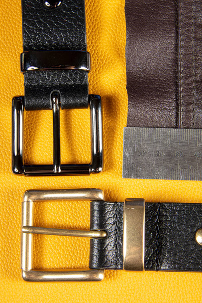 Part of leather belts with metal buckles. - Fotografie, Obrázek