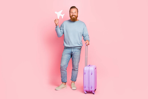 Full size portrait of positive person hand hold small plane figure isolated on pink color background. - Zdjęcie, obraz