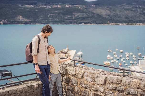 Father and son tourists in Herceg Novi old town. Historical and touristic center of Herceg Novi. Montenegro. - Foto, afbeelding
