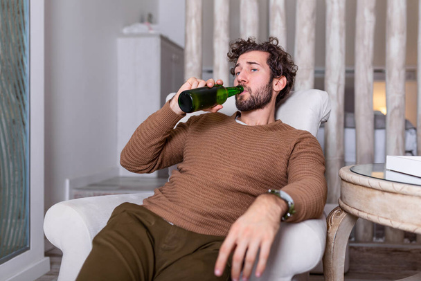 Sad sports fan sitting in an sofa and watching a match on television with his team losing the game . man watching football or soccer game on tv at home and drinking beer - Zdjęcie, obraz