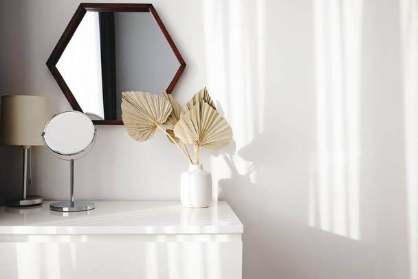 Modern minimal interior in white colors, vase with dry leaves, natural light - Fotografie, Obrázek