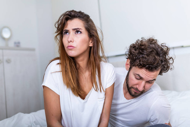 Couple With Problems Having Disagreement In Bed. Frustrated couple arguing and having marriage problems, Young couple into an argument on bed in bedroom - Photo, Image