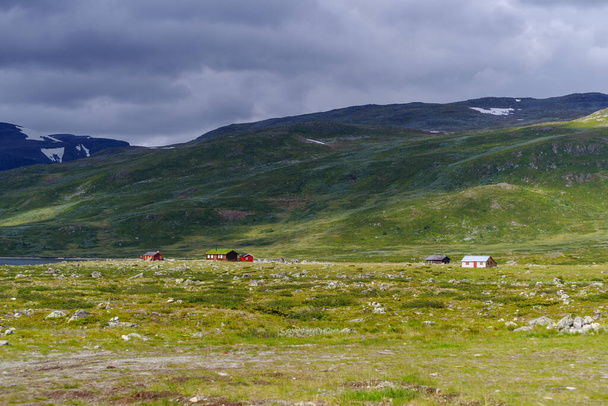 typical norwegian houses in a beautiful green mountain landscape - Photo, image