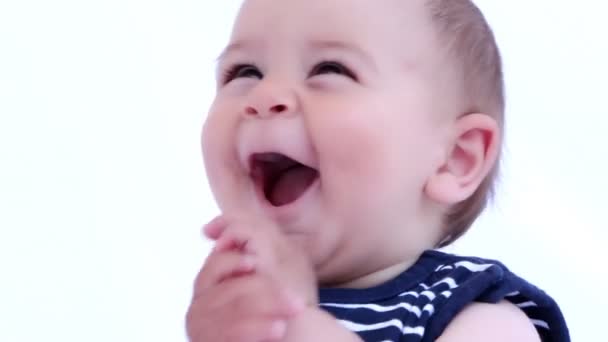 Happy baby boy is laughing and clapping with hands on a white background - Footage, Video