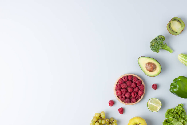 Fresh fruits and vegetables on grey background. Healthy eating concept. Flat lay, copy space. - 写真・画像