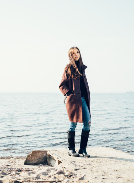 Outdoor portrait of young pretty woman posing near the sea  - Foto, immagini