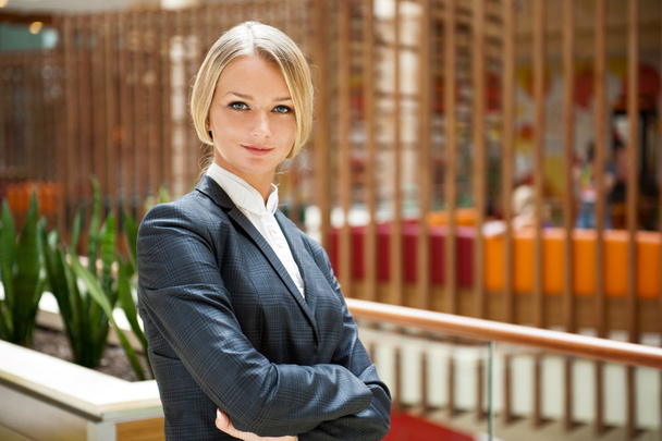 Portrait of a cute business standing woman with hands folded ins - Фото, зображення