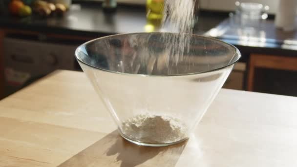 Beautiful shot of pouring flour into glass bowl, making dough, homemade bakery, counter light, Close up, Slow motion. - Footage, Video
