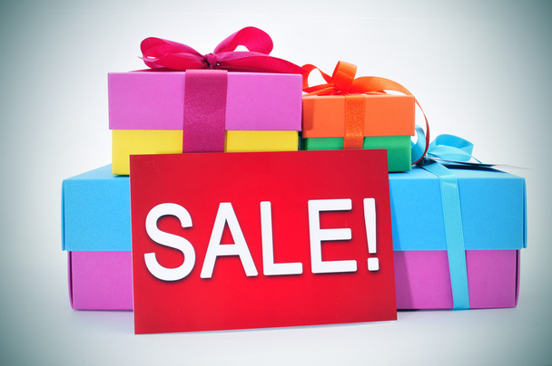 gifts and a red signboard with the word sale - Foto, Imagem