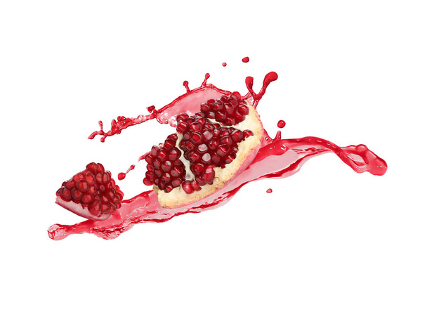 Fresh ripe pomegranate and splash of juice on white background - Foto, afbeelding