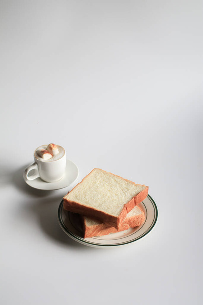 Slice Bread with hot coffee and marshmallow on white background.  Morning breakfast with coffee, butter and toasts. - Photo, Image