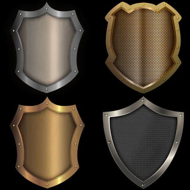 Gold and silver shields set on black background. - Foto, imagen