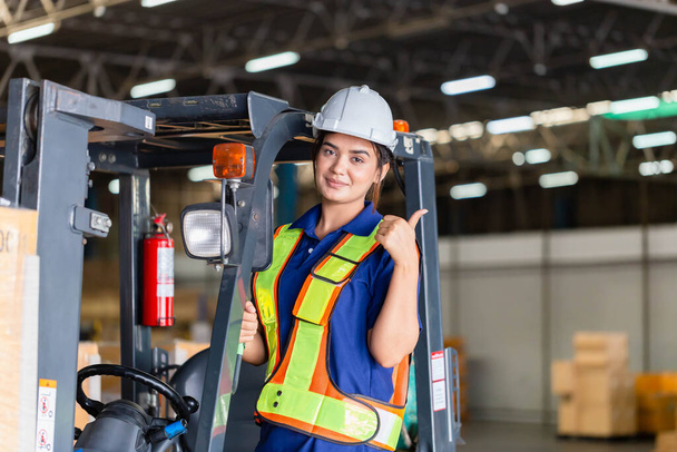 Cheerful female worker on forklift, Manual workers working in warehouse, Worker driver at warehouse forklift loader works - Fotoğraf, Görsel
