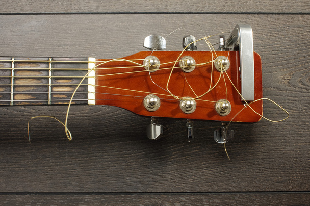 Top view of guitar headstock on the wooden table - Photo, Image