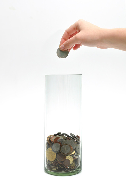 dropping coin into glass jar - Photo, Image