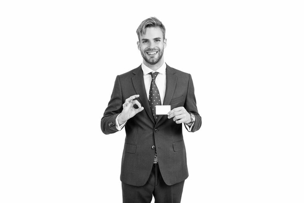 happy confident successful businessman man in businesslike suit showing empty credit or debit business card with ok gesture, copy space, business. - Foto, Imagen