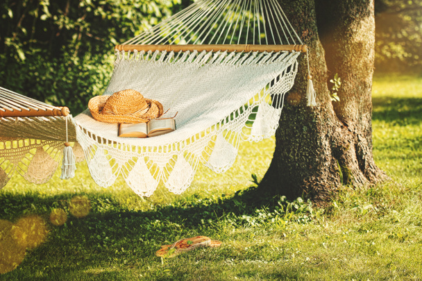 View of hammock and book on a summer day - Fotoğraf, Görsel