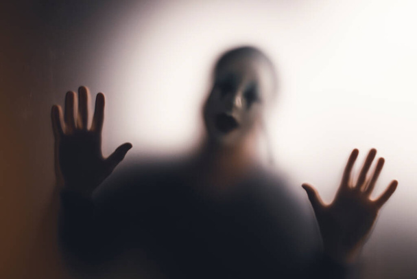 Horror ghost woman behind the matte glass. Halloween festival concept. - Foto, Bild