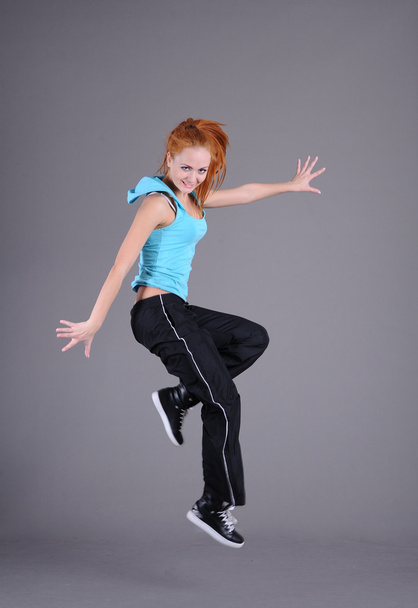 Young woman jumping and dancing - Fotografie, Obrázek