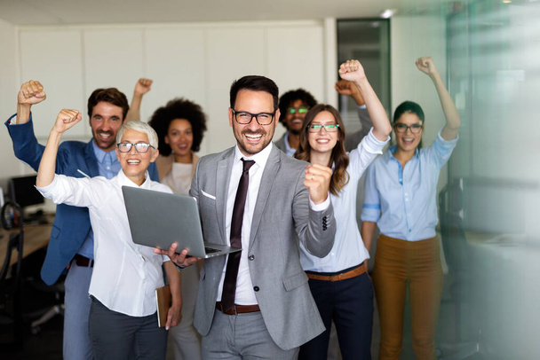 Happy group of multiethnic business team celebrating a good job in the office. Business and finance concept. - Foto, Imagen