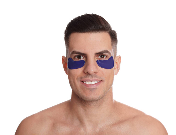 Man with blue under eye patches on white background - Fotoğraf, Görsel