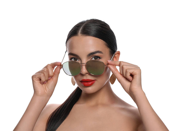 Attractive woman wearing fashionable sunglasses on white background - Fotó, kép