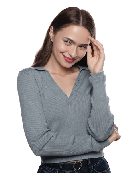 Embarrassed young woman covering face with hand on white background - Фото, зображення