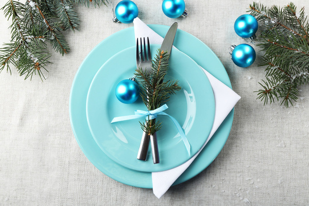 Stylish blue and white Christmas table setting on grey tablecloth background - Fotó, kép
