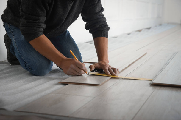 Worker installing new laminate flooring in room, closeup - Foto, Imagem
