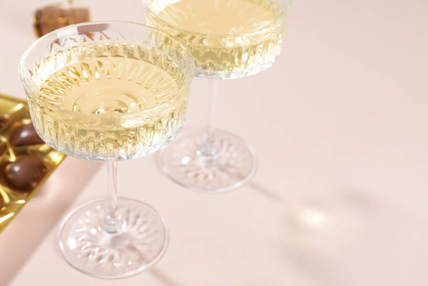 Glasses of expensive white wine on pink background, closeup. Space for text - Foto, Bild