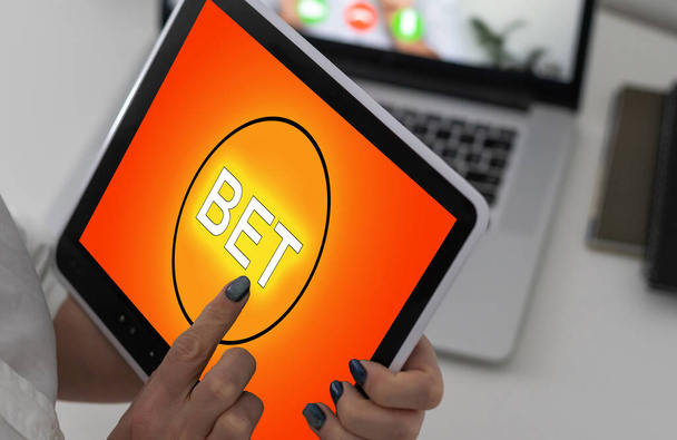 hands of a woman holding a online betting device. All screen graphics are made up - Photo, Image