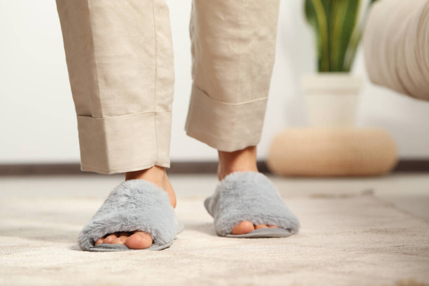 Woman wearing soft slippers at home, closeup - Fotografie, Obrázek