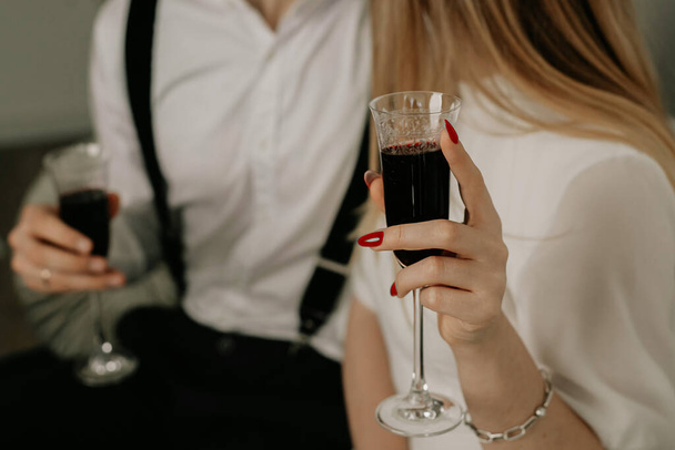 boy and girl hold red wine in glass - Photo, Image