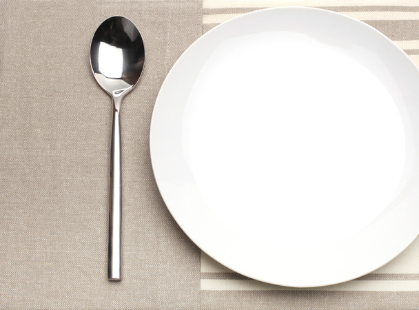 Empty plate with spoon - Fotó, kép